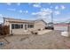 The home's backyard has a mix of gravel and concrete surfaces, plus a metal shed for extra storage at 1418 5Th St, Fort Lupton, CO 80621