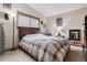 Comfortable bedroom featuring a large bed, window, carpet, and warm lighting at 1418 5Th St, Fort Lupton, CO 80621