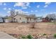 This single story home has a large front yard and a detached garage at 1418 5Th St, Fort Lupton, CO 80621