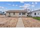 Charming single-story home with a well-maintained exterior and walkway at 1418 5Th St, Fort Lupton, CO 80621