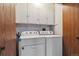 Functional laundry room with a washer and dryer, ample storage cabinets, and practical layout at 1418 5Th St, Fort Lupton, CO 80621