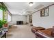 Spacious living room featuring neutral paint, carpet, with views to a staircase and large window at 1418 5Th St, Fort Lupton, CO 80621