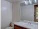 Half bath with wooden vanity, white countertop, and neutral paint at 3515 S Dawson St, Aurora, CO 80014