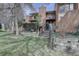 Charming townhouse exterior with multi-level decks, brick accents, lush landscaping, and inviting entrance at 3515 S Dawson St, Aurora, CO 80014