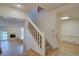 Entry foyer with staircase and hardwood floors that leads to living room with fireplace at 3515 S Dawson St, Aurora, CO 80014