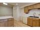 Galley kitchen featuring wood cabinets, black sink, and laminate countertops at 3515 S Dawson St, Aurora, CO 80014