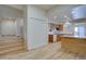 Open kitchen with wood floors, white cabinets, breakfast bar, and lots of light at 3515 S Dawson St, Aurora, CO 80014