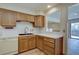 Well-lit kitchen featuring oak cabinets, white countertops, and a breakfast nook at 3515 S Dawson St, Aurora, CO 80014