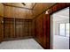 Cozy living room with wood paneled walls and ceiling and built-in shelving at 3515 S Dawson St, Aurora, CO 80014