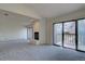 Bright living room with fireplace and sliding doors leading to a wooden deck with scenic views at 3515 S Dawson St, Aurora, CO 80014