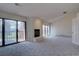 Open living room with a white brick fireplace, sliding glass doors, and neutral carpet at 3515 S Dawson St, Aurora, CO 80014