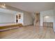 Hardwood floors flow through living space featuring brick fireplace and wet bar at 3515 S Dawson St, Aurora, CO 80014