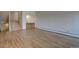 Spacious living room with hardwood floors adjoins stairs and wet bar area at 3515 S Dawson St, Aurora, CO 80014