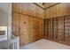 A rustic living room featuring wood paneled walls, built-in shelving, and plenty of natural light at 3515 S Dawson St, Aurora, CO 80014