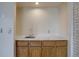 This wet bar features wood cabinets, laminate countertops, and stainless steel sink at 3515 S Dawson St, Aurora, CO 80014