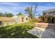 Backyard with grass, small sheds, partial fencing and a small area with a concrete patio at 2415 Chase St, Edgewater, CO 80214