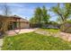 Backyard featuring a small concrete patio, pergola and shed with grass area at 2415 Chase St, Edgewater, CO 80214