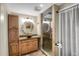Bathroom with a vessel sink, granite countertops, and a tiled shower with glass door and vanity at 2415 Chase St, Edgewater, CO 80214