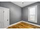 Empty bedroom featuring hardwood floors and a window at 2415 Chase St, Edgewater, CO 80214