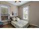 Cozy bedroom featuring a floral pattern comforter and hardwood floors at 2415 Chase St, Edgewater, CO 80214