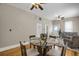 Comfortable open-concept space with hardwood floors and a cozy dining table providing a great place for gatherings at 2415 Chase St, Edgewater, CO 80214