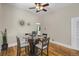 Charming dining area featuring hardwood floors, a modern glass table, and unique wall decorations for stylish dining at 2415 Chase St, Edgewater, CO 80214