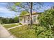 Lovely home with a cozy front porch, well-kept lawn, and mature trees, offering a charming and inviting atmosphere at 2415 Chase St, Edgewater, CO 80214