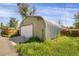 View of the garage exterior, with metal frame and roll up door at 2415 Chase St, Edgewater, CO 80214