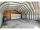 Spacious garage with roll up door, metal frame and concrete floor at 2415 Chase St, Edgewater, CO 80214