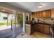 Well-lit kitchen with wooden cabinets and outdoor access at 2415 Chase St, Edgewater, CO 80214