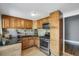 Kitchen with wooden cabinets and stainless steel appliances at 2415 Chase St, Edgewater, CO 80214