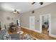 Open-concept living area featuring hardwood floors, a ceiling fan and decorative accents, great for entertaining at 2415 Chase St, Edgewater, CO 80214