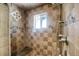 Walk-in shower with tile surround, a stone seat, rainfall shower head, and hand-held shower wand at 2415 Chase St, Edgewater, CO 80214