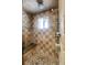 Walk-in shower with tile surround, stone seat, rainfall shower head, and hand-held shower wand at 2415 Chase St, Edgewater, CO 80214