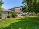 Spacious yard featuring a well maintained lawn, mature trees, and a cozy patio area at 12555 Eastlake Dr, Thornton, CO 80241