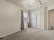 Comfortable bedroom features plush carpet, neutral walls and a window at 12555 Eastlake Dr, Thornton, CO 80241