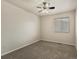 Comfortable bedroom featuring neutral carpet, white walls and a single window at 12555 Eastlake Dr, Thornton, CO 80241