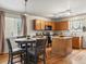 Eat-in kitchen with hardwood floors, an island, and wood cabinets at 12555 Eastlake Dr, Thornton, CO 80241
