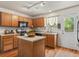 Charming kitchen featuring wood cabinets, central island, and stainless steel appliances at 12555 Eastlake Dr, Thornton, CO 80241