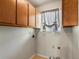Dedicated laundry room space with upper cabinets for storage and a window for ventilation at 12555 Eastlake Dr, Thornton, CO 80241