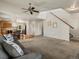 Cozy living room showcasing an open floor plan with views of the dining area and staircase at 12555 Eastlake Dr, Thornton, CO 80241
