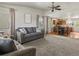 Bright living room with neutral carpet, ceiling fan, and adjoined dining area at 12555 Eastlake Dr, Thornton, CO 80241