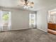Spacious main bedroom with two windows, neutral carpet, and ensuite bath at 12555 Eastlake Dr, Thornton, CO 80241