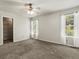 Bright main bedroom with plush carpet, a ceiling fan, and a walk-in closet at 12555 Eastlake Dr, Thornton, CO 80241