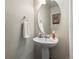 Pedestal sink powder room with decorative oval mirror, neutral paint color at 12555 Eastlake Dr, Thornton, CO 80241