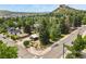 Aerial view of home, detached garage, Airstream and mature trees with a view of the surrounding town at 403 Anderson St, Castle Rock, CO 80104