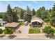 Scenic aerial view featuring a house, garage, vintage camper, and well-manicured grounds at 403 Anderson St, Castle Rock, CO 80104
