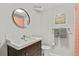 Bathroom featuring a dark vanity, mirror, and shower with orange curtain at 403 Anderson St, Castle Rock, CO 80104