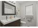 Modern bathroom with a double sink vanity, a large mirror, and a bright window, creating a clean and functional space at 403 Anderson St, Castle Rock, CO 80104