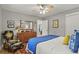 Comfortable bedroom featuring hardwood floors, a ceiling fan, a dresser, and a bright window, creating a cozy atmosphere at 403 Anderson St, Castle Rock, CO 80104